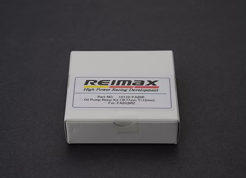 A white cardboard product box for a Reimax oil pump rotor kit, photographed on a dark gray background. The front label features the Reimax brand name and part details.