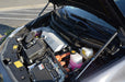 Car engine compartment with various components visible