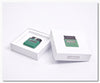 Two green electronic devices in white boxes on a white background