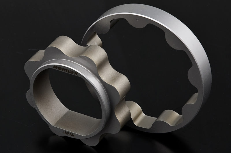 Two metallic bicycle chain guard plates, one with a hexagonal end and the other as a flat ring, both featuring a scalloped inner edge. The brand name 'Rimex' is visible on the hexagonal end, and 'JAPAN' is printed near the bottom.