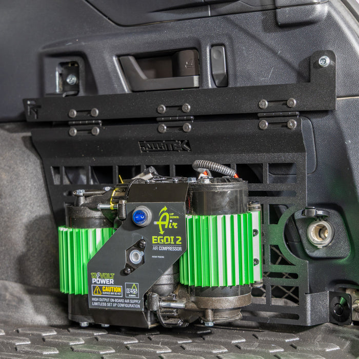 subaru outback molle panel installed in rear cargo storage area with air compressor mounted on it