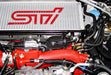 A close-up image of an HKS Super SQV4 Black Edition GDB for EJ205/EJ255/EJ257 engines, showing the product's placement in an automotive setting, specifically focusing on the product's design and the surrounding engine components.